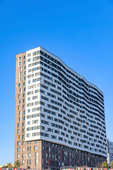 Fototapeta na wymiar Modern residential apartment building on blue sky 