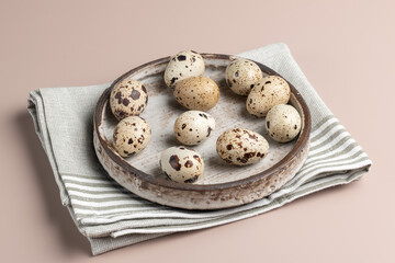 Quail egg in the plate on beige background