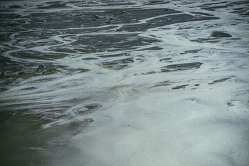 Atmospheric landscape with many channels near shallow lake. Minimal backdrop of dark green water in...