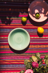 overhead view image of two soup plates on a colorful table cloth