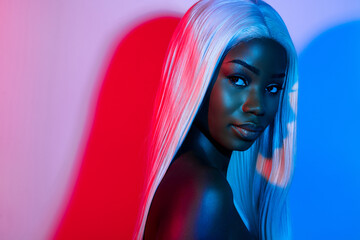 Photo of young stunning peaceful african girl in artificial wig enjoying nightlife party isolated...