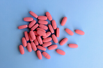 Pharmaceutical medicine pills over blue background