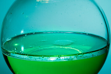 Glass flask. Liquid and crystals. Colored liquid.