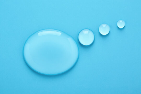 Water drops in shape of Thought bubble on blue background. Transparent liquid speech balloon. Place for text.