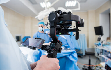 The videographer shoot the surgeon and assistants in the operating room with surgical equipment