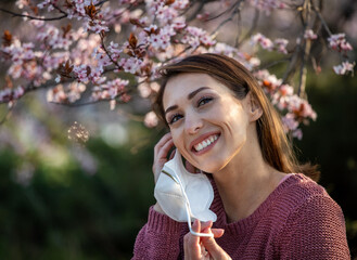 Girl putting facial mask on for pollen allergy protection