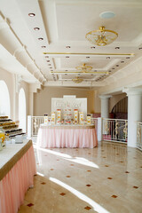 Festive table for the bride and groom decorated with cloth and flowers. Concept fresh floral