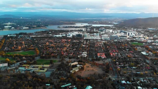 Canberra City Centre Upwards Flying Drone Shot At Sunset Overlooking Canberra City Centre, With Lake Burley Griffin In The Background. Canberra, Australia