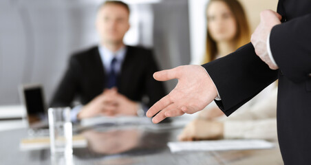 Business presentation. Unknown businessman giving a speech to colleagues or partners at corporate conference. Meeting concept