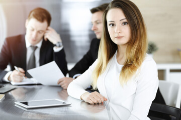 Fototapeta premium Business woman headshot in sunny office. Unknown businesswoman sitting behind computer monitor