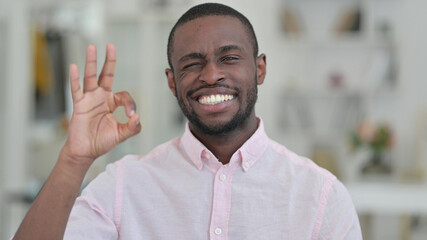 Portrait of Positive African Man doing OK Sign 