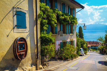 Rivaz village street view with flowery house and Geneva lake
