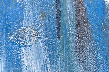 The metal surface painted with multicolored colors speckles and stripes is sloppy