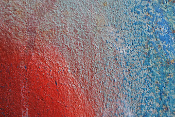 The metal surface painted with multicolored colors speckles and stripes is sloppy