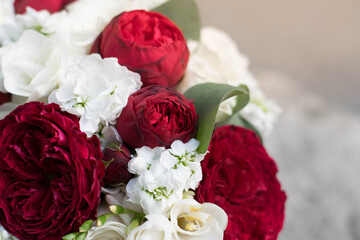 Beautiful bridal bouquet of red roses and white freesia.