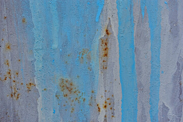 The metal surface painted with multicolored colors speckles and stripes is sloppy