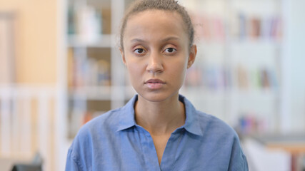 Fototapeta premium Portrait of Serious African Woman Looking at Camera