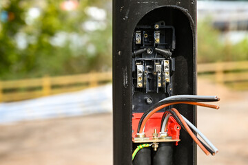 Base of a street light with cover open showing the installation of wiring