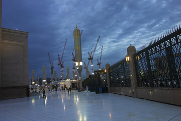 Beautiful shots of the Holy Masjid al Nabawi at evening time with White MInarets and the Green dome 
