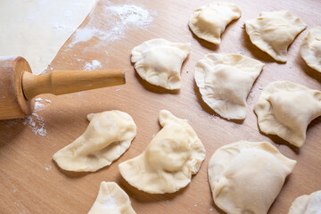 Raw dumplings on a board. Traditional homemade food