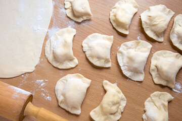 Fototapeta na wymiar Raw dumplings on a board. Traditional homemade food