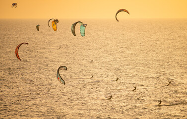 A view from above on kites and people kitesurfing.