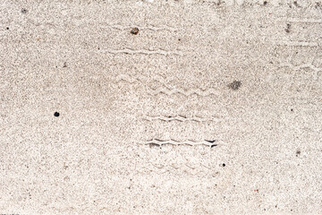 Traces of car tires on a road marking. City environment. Top view close up.