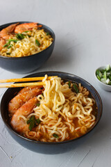 Ramen soup with prawns and green onions.