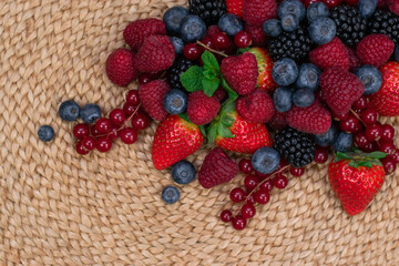 Raspberry, blackberry and blueberryon wood table. Close up. Top view.
