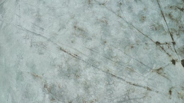 Melting spring ice close-up. Frozen ground visible from under the snow. White snow, melt ice, early spring. . High quality. 4k footage.