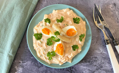 Asparagus salad with ham, egg, in a creamy mayonnaise ketchup dressing and herbs.