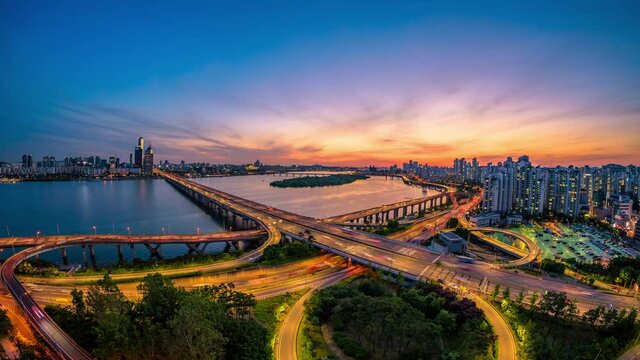 Time lapse day 2 night traffic zips through an intersection view of Mapo Bridge Seoul ,South Korea.
