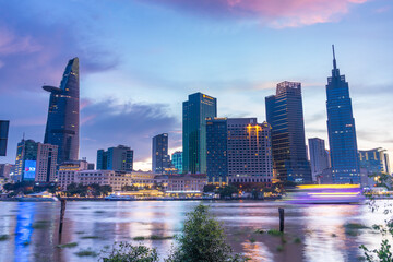 Fototapeta premium Bitexco Financial Tower building, buildings, roads and Saigon river in Ho Chi Minh city - This city is a popular tourist destination of Vietnam. Business and landscape concept.