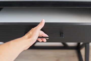 Trendy modern furniture, tube, woman's hand opening the top drawer