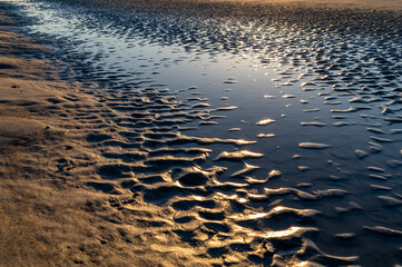 Photo of Tidal Pool in Mud Flats with sand patterns