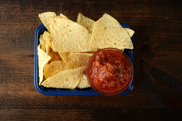  nacho chips with salsa in plastic container