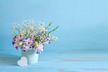 Bouquet of flowers on blue background with copy space.