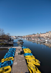 Naklejka premium Spring view over pedaling boats at a jetty in Stockholm inner harbor