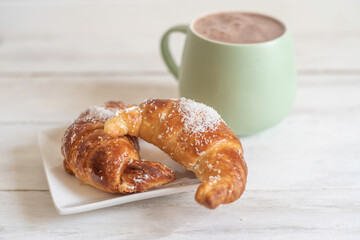Sweet croissant with coconut flakes. Food for breakfast.