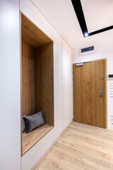 Corridor in modern design apartment with closet and seat