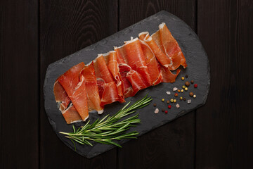 Prosciutto Parma, on a wooden background, top view, horizontal, no people,
