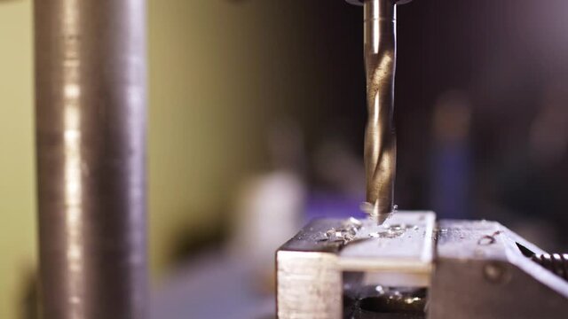 Shot of a drilling machine rotation at the workplace of a toolman locksmith, UHD 4k macro video
