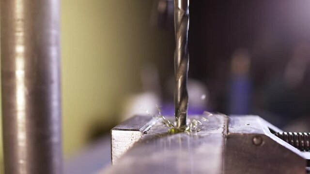 Shot of a drilling machine rotation at the workplace of a toolman locksmith, UHD 4k macro video