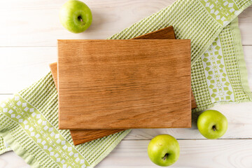 green apples empty wooden cutting board