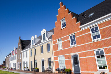 Fototapeta na wymiar Row of houses in old dutch style in Blauwestad