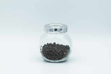 Fototapeta na wymiar black pepper in glass bottle isolated on white background