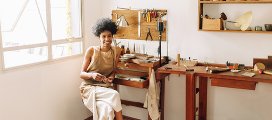 Worker sitting in jewelry workshop