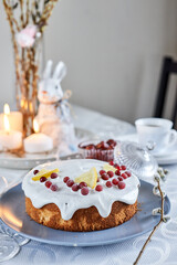Easter decoration, candles and bunny and lemon biscuit