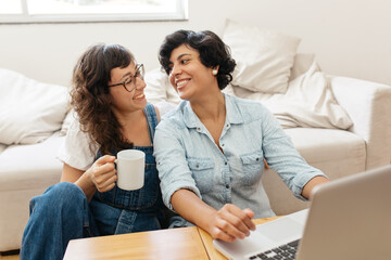 Loving female couple together at home