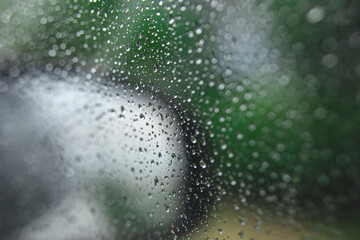 Drops on glass in rainy day. Texture of raindrops, wet glass. heavy rain, bad weather, loneliness, isolation. The texture of the wet surface, background, beautiful wallpaper.